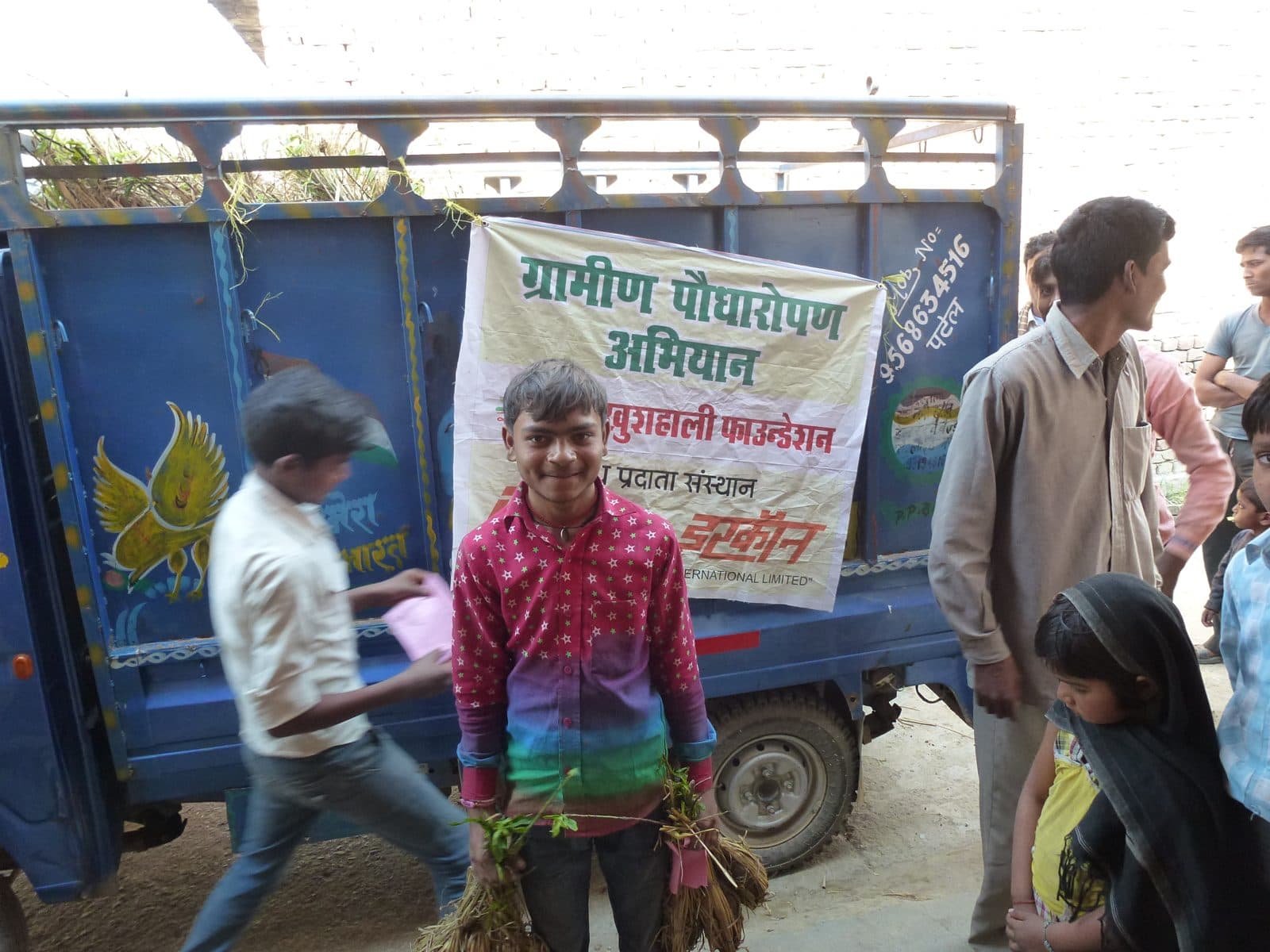 A truck of saplings arrives in a village, February 2017