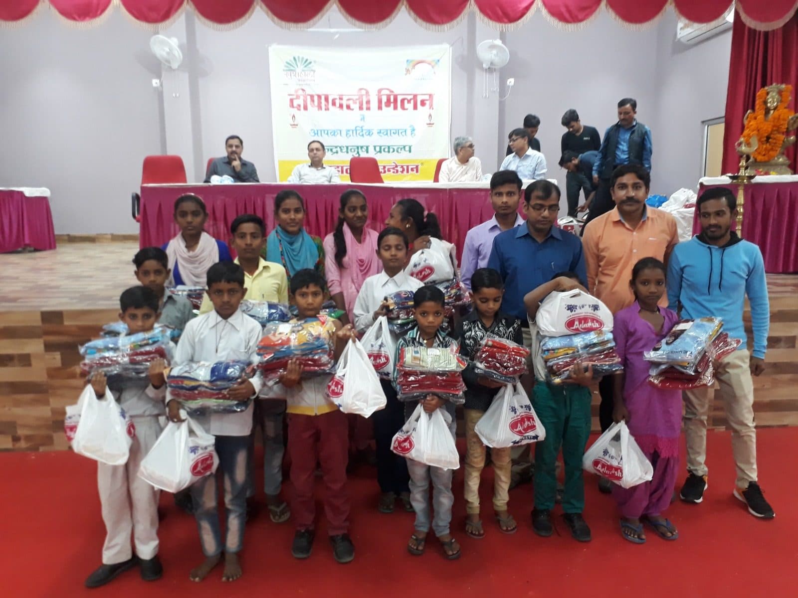 Children hold their Deepawali gifts at the Indradhanush Deepawali Milan