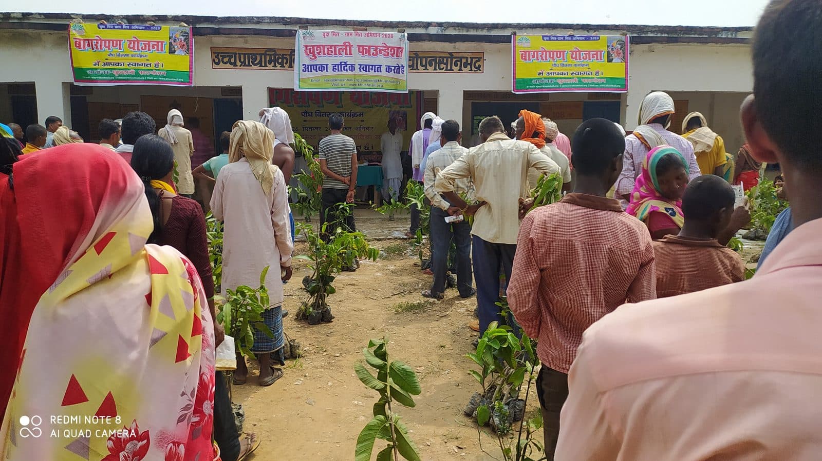 Women carrying fruit saplings home after the 26 September 2020 camp